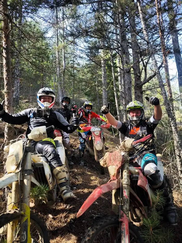 Rider tackling a river crossing on a Bulgarian enduro tour