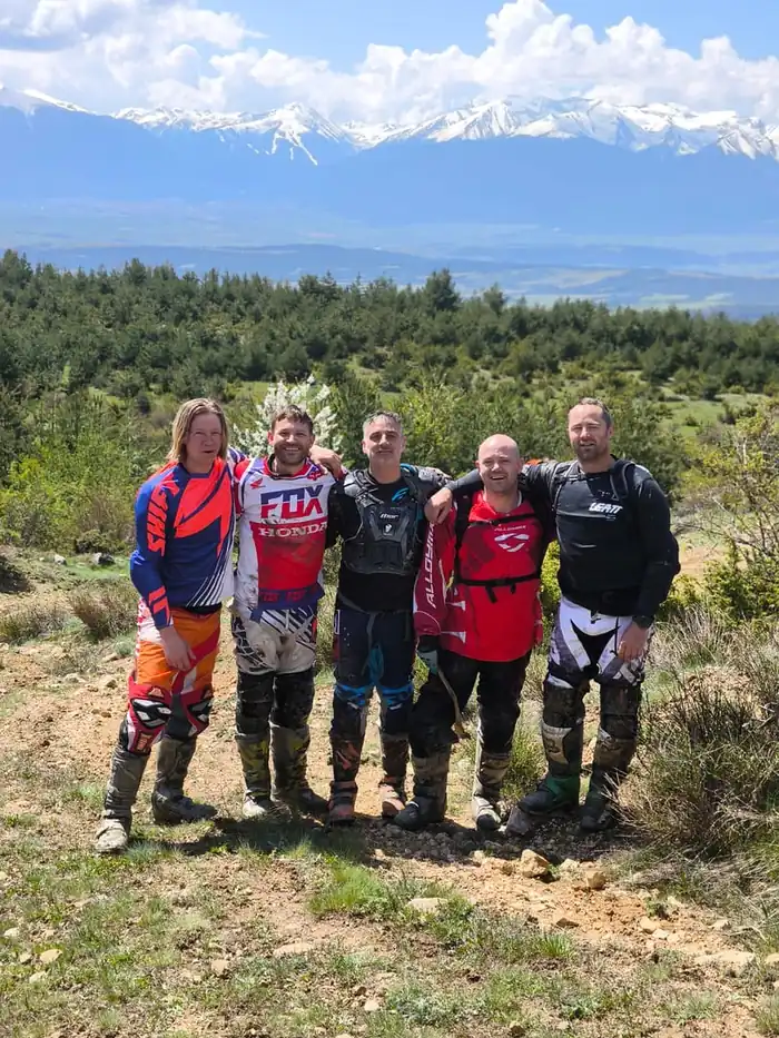 Guided enduro tour group crossing a forest trail in Bulgaria